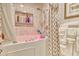 Bathroom featuring a shower over tub with pink water, decorative tile, and a privacy curtain at 4396 Baldwin Ave. # 1, Little River, SC 29566