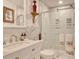Modern bathroom featuring marble-style walls, glass shower doors, and white fixtures at 4396 Baldwin Ave. # 1, Little River, SC 29566