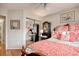 Bright bedroom featuring orange patterned bedding and furniture, alongside mirrored closet doors at 4396 Baldwin Ave. # 1, Little River, SC 29566