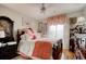 Well-lit bedroom with a four-poster bed, area rug, ceiling fan, wood floors, and decorative accents at 4396 Baldwin Ave. # 1, Little River, SC 29566