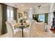 Elegant dining room featuring a modern glass table, sophisticated decor, and abundant natural light at 4396 Baldwin Ave. # 1, Little River, SC 29566