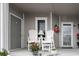 Inviting covered front porch featuring white Adirondack chairs with view, perfect for relaxing or enjoying your morning coffee at 4396 Baldwin Ave. # 1, Little River, SC 29566