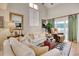 Bright living room with vaulted ceilings, neutral paint, a ceiling fan, large windows, and sliding glass door access to the outside at 4396 Baldwin Ave. # 1, Little River, SC 29566