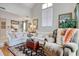 Comfortable living room showcasing seating, an area rug, hardwood floors, and access to the dining area at 4396 Baldwin Ave. # 1, Little River, SC 29566