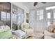 Bright sunroom with wicker chairs, patterned cushions, tiled floor and a glass sliding door at 4396 Baldwin Ave. # 1, Little River, SC 29566
