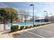 Well-maintained community tennis court with blue surface, parking, and surrounding trees at 4396 Baldwin Ave. # 1, Little River, SC 29566