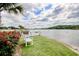 Relaxing waterfront view with white bench, lush greenery, and calming water scenery at 4396 Baldwin Ave. # 1, Little River, SC 29566