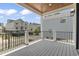 Expansive covered balcony offers serene neighborhood views with stylish wood accents and black railings at 4617 Hedrick St., North Myrtle Beach, SC 29582