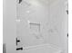 Modern tub and shower area with elegant white marble tile and built-in niche at 4617 Hedrick St., North Myrtle Beach, SC 29582