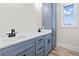 Stylish bathroom featuring double sinks with black hardware, white countertops, and blue cabinetry at 4617 Hedrick St., North Myrtle Beach, SC 29582
