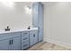 Stylish bathroom featuring a sleek, powder blue vanity with dual sinks and modern fixtures at 4617 Hedrick St., North Myrtle Beach, SC 29582