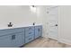 Elegant bathroom with double sinks, quartz countertops, and modern blue cabinetry with black hardware at 4617 Hedrick St., North Myrtle Beach, SC 29582