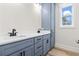 Elegant bathroom featuring double sinks, modern fixtures, and ample storage within the gray cabinets at 4617 Hedrick St., North Myrtle Beach, SC 29582