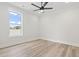 Bright bedroom with wood floors, a ceiling fan, and a large window with pleasant outdoor views at 4617 Hedrick St., North Myrtle Beach, SC 29582