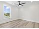 Bright bedroom featuring wood floors, a ceiling fan, and a large window with pleasant views at 4617 Hedrick St., North Myrtle Beach, SC 29582