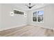 Bright and airy bedroom with wood floors, two large windows, and modern ceiling fan at 4617 Hedrick St., North Myrtle Beach, SC 29582
