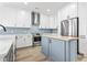 Modern kitchen features a butcher block island, stainless steel appliances, and designer finishes at 4617 Hedrick St., North Myrtle Beach, SC 29582