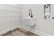 Clean laundry room with modern fixtures, a deep sink, and storage shelves for convenience at 4617 Hedrick St., North Myrtle Beach, SC 29582