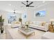 Bright living room with white furniture, area rug, fan, and a sliding glass door to a balcony at 4617 Hedrick St., North Myrtle Beach, SC 29582
