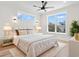 Comfortable main bedroom with a ceiling fan, soft decor, and large windows providing natural light and scenery at 4617 Hedrick St., North Myrtle Beach, SC 29582