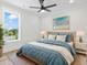 Stylishly decorated bedroom with a ceiling fan, cozy decor, and a large window offering natural light at 4617 Hedrick St., North Myrtle Beach, SC 29582