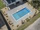 Aerial view of a modern rectangular pool surrounded by lush landscaping and a secure fence at 4617 Hedrick St., North Myrtle Beach, SC 29582