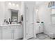 Bright bathroom with dual sink vanities, white cabinets, framed mirrors, and neutral color palette at 462 Pacific Commons Dr., Surfside Beach, SC 29575