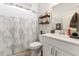 Bright bathroom featuring a white vanity, decorative mirror, shower, and neutral color palette at 462 Pacific Commons Dr., Surfside Beach, SC 29575
