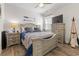 Well-decorated bedroom with a wooden bed frame, nautical decor, and a ceiling fan at 462 Pacific Commons Dr., Surfside Beach, SC 29575