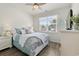 Bright bedroom with a comfortable bed, ceiling fan, and ample natural light from the window at 462 Pacific Commons Dr., Surfside Beach, SC 29575