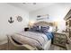 Nautical-themed bedroom featuring a queen bed with striped bedding and matching anchor-themed lamps on the nightstands at 462 Pacific Commons Dr., Surfside Beach, SC 29575
