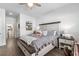 Comfortable bedroom with a ceiling fan, gray toned bedding, and a gray rug over vinyl plank flooring at 462 Pacific Commons Dr., Surfside Beach, SC 29575