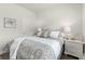 Comfortable bedroom featuring a beautifully dressed bed with white nightstands and matching lamps at 462 Pacific Commons Dr., Surfside Beach, SC 29575