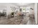 Bright dining room featuring white walls, decorative rug on vinyl plank flooring, pendant lighting, and a charming dining table at 462 Pacific Commons Dr., Surfside Beach, SC 29575
