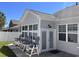 Back patio with outdoor seating and view of the back exterior of the sunroom at 462 Pacific Commons Dr., Surfside Beach, SC 29575