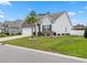 Charming single-story home with a lush green lawn and a neatly landscaped yard and palm tree at 462 Pacific Commons Dr., Surfside Beach, SC 29575
