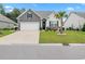 Charming single-story home featuring a well-manicured lawn, palm tree, and a two-car garage at 462 Pacific Commons Dr., Surfside Beach, SC 29575