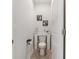 Charming half-bathroom featuring white walls, wood look floors, and creative decor and artwork at 462 Pacific Commons Dr., Surfside Beach, SC 29575