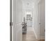Hallway view leads to bright bathroom with double vanity, framed mirror, and decorative lighting at 462 Pacific Commons Dr., Surfside Beach, SC 29575