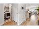 Hallway with wood floors leading to an open kitchen and laundry room with a white washer and dryer at 462 Pacific Commons Dr., Surfside Beach, SC 29575