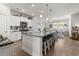 Modern kitchen with granite countertops, stainless steel appliances, and a large island with seating at 462 Pacific Commons Dr., Surfside Beach, SC 29575