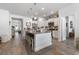 Spacious kitchen featuring granite countertops, stainless steel appliances, a large island, and hardwood floors at 462 Pacific Commons Dr., Surfside Beach, SC 29575