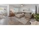 Inviting living room with a large sectional sofa, a ceiling fan, and large windows for natural light at 462 Pacific Commons Dr., Surfside Beach, SC 29575