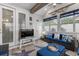 Light-filled sunroom with coastal decor, wicker furniture, and access to the outdoors at 462 Pacific Commons Dr., Surfside Beach, SC 29575