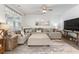 Comfortable living room with a large sectional sofa, a ceiling fan, and modern decor at 462 Pacific Commons Dr., Surfside Beach, SC 29575