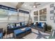 Bright sunroom with wicker furniture, blue cushions, wood beam, and lots of natural light at 462 Pacific Commons Dr., Surfside Beach, SC 29575