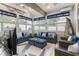 Coastal-themed living room with wicker furniture, blue accents, natural light, and vaulted ceilings at 462 Pacific Commons Dr., Surfside Beach, SC 29575