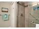 Bathroom walk-in shower with stone tile and a variety of shower products at 4800 S Ocean Blvd. # 1221, North Myrtle Beach, SC 29582