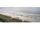 Aerial shot of a beach with umbrellas, lounge chairs, and people enjoying the ocean at 4800 S Ocean Blvd. # 1221, North Myrtle Beach, SC 29582
