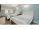 Bedroom with two beds, light blue decor, and plantation shutters at 4800 S Ocean Blvd. # 1221, North Myrtle Beach, SC 29582